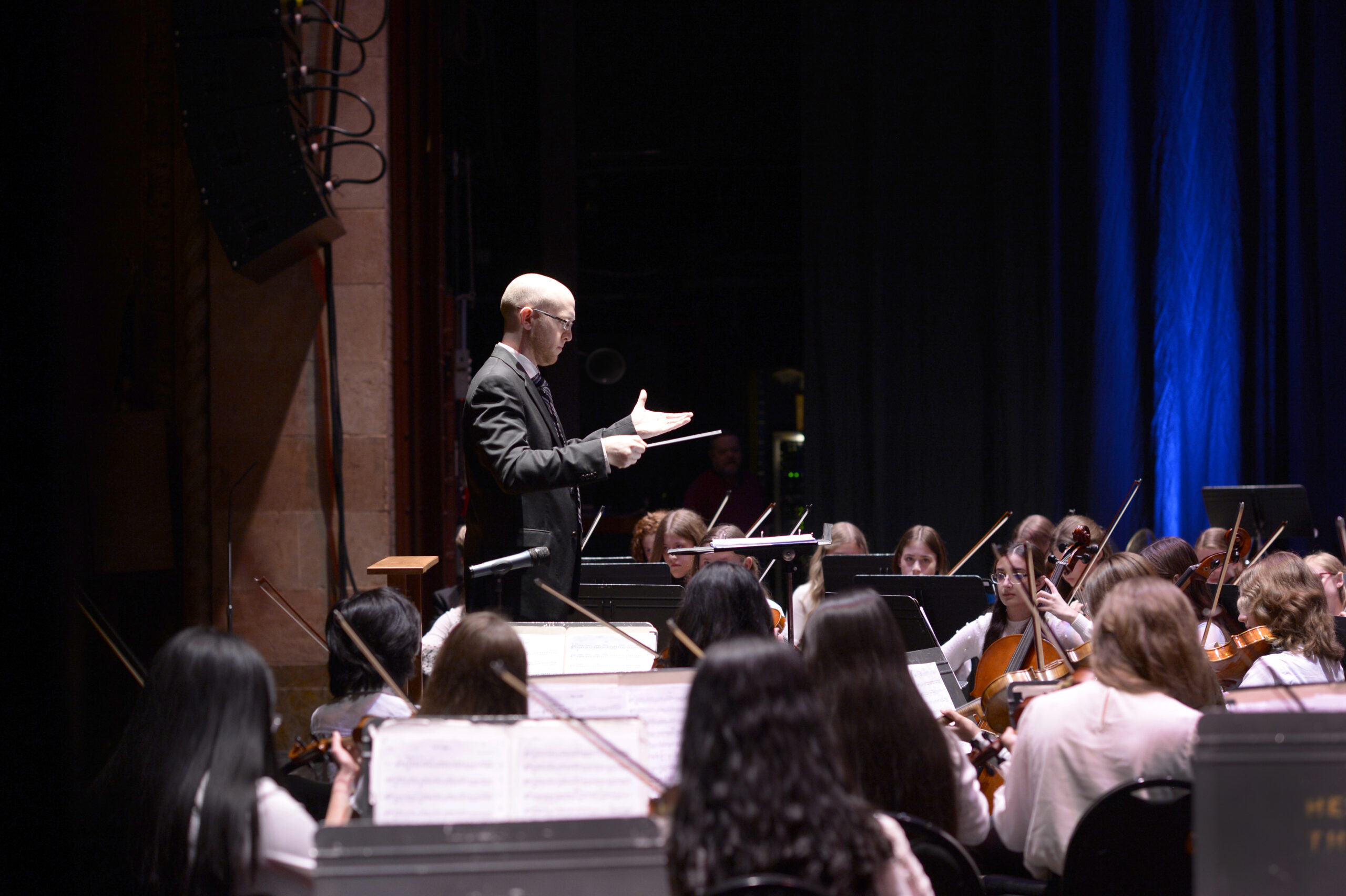 conductor and youth orchestra onstage
