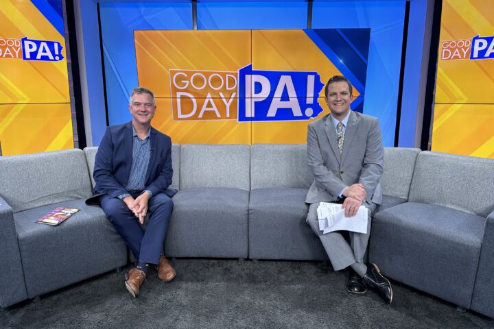 two men on a couch on a TV news set. The backdrop says "Good Day PA!"