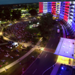 overhead view of building with red, white, and blue lights at night